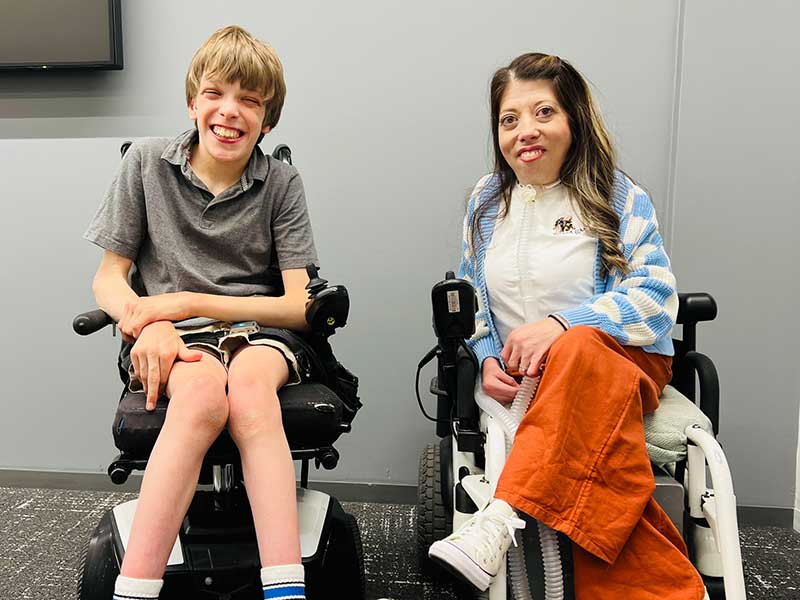 portrait of a young man and a woman, both in wheelchairs