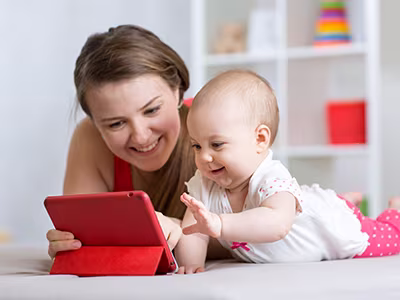 Mother and baby playing with a tablet